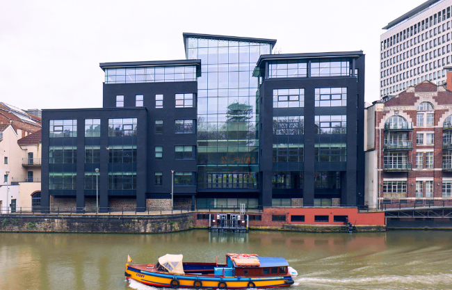 Riverside commercial property, charcoal coloured fascade with glass 